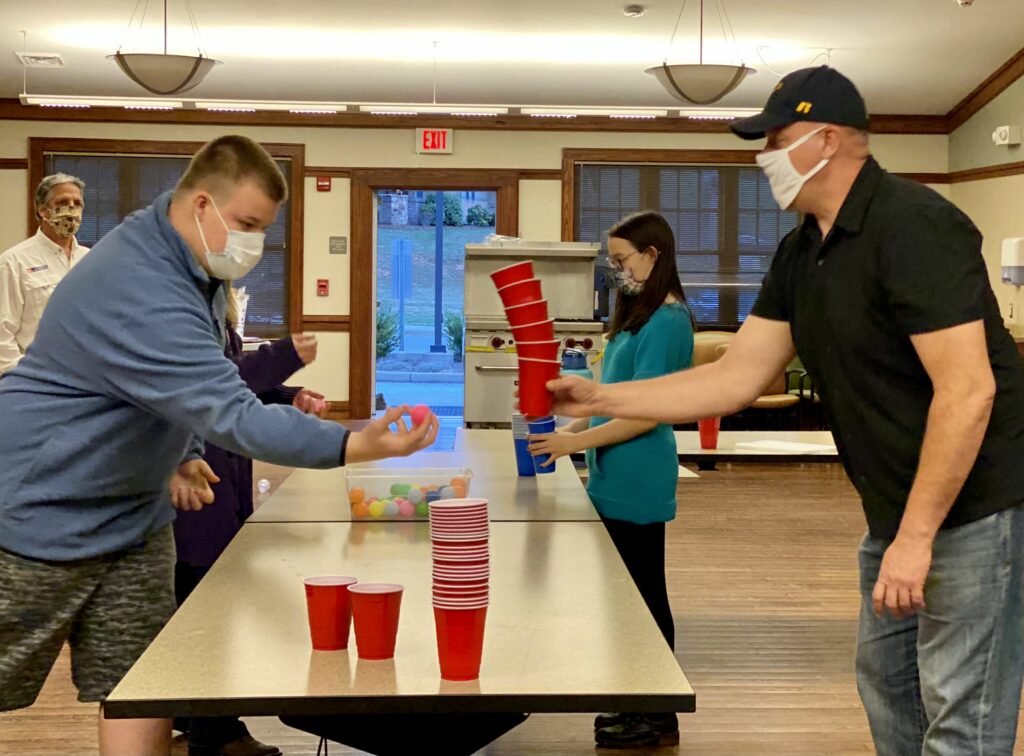 Families stacking balls and cups
