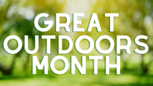 Great Outdoors Month in text on blurred tree background